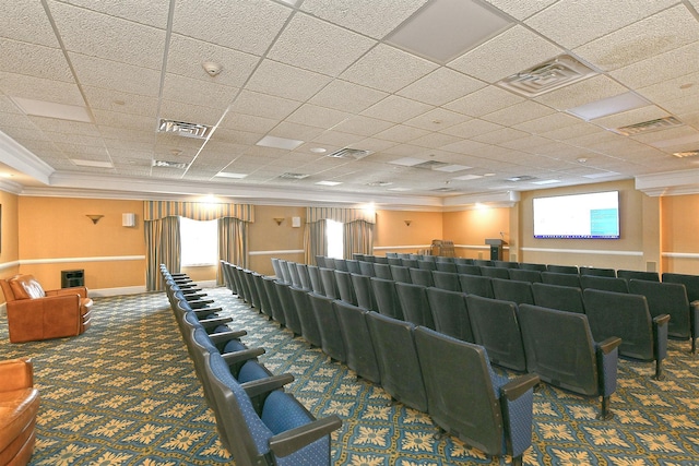 cinema room with carpet floors, ornamental molding, and visible vents