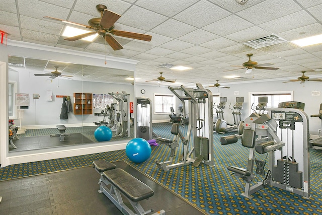 workout area with a paneled ceiling, visible vents, and baseboards