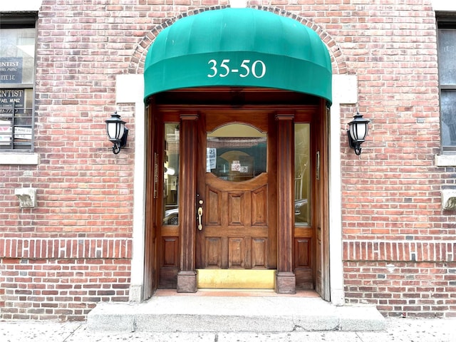 entrance to property with brick siding