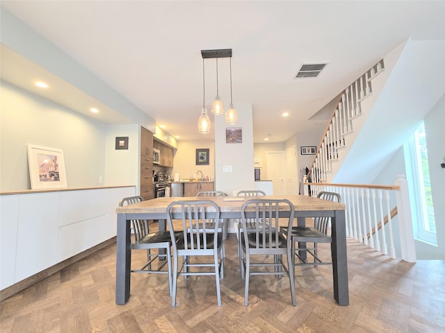 dining space featuring stairs, visible vents, and recessed lighting