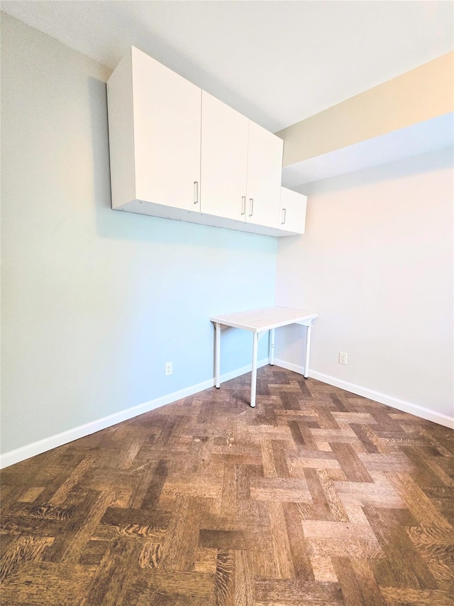 laundry area featuring baseboards