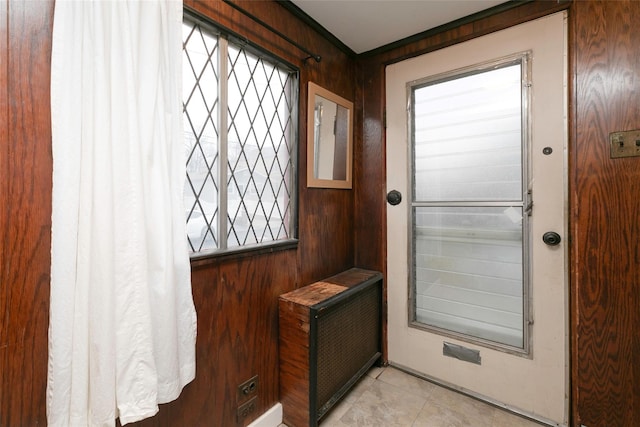 doorway to outside with light tile patterned flooring