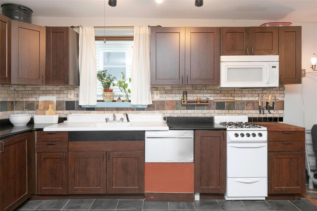 kitchen with decorative backsplash and white appliances