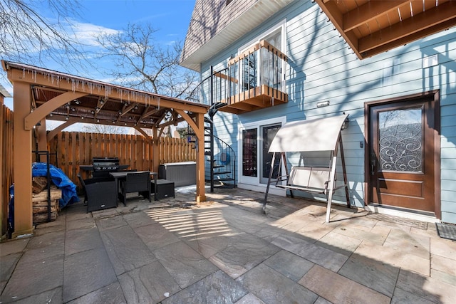 view of patio / terrace with outdoor dining space, fence, and a balcony