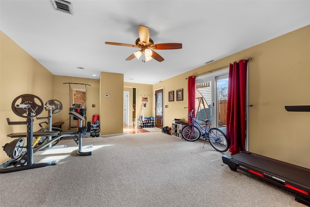 workout room featuring ceiling fan, carpet, and visible vents