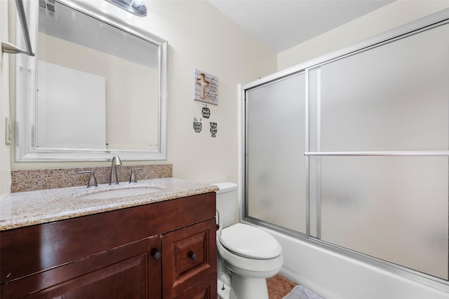 bathroom featuring toilet, shower / bath combination with glass door, visible vents, and vanity