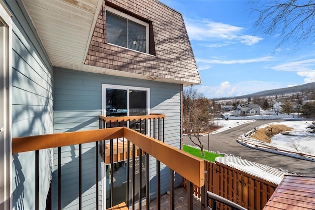 snow covered deck featuring a mountain view