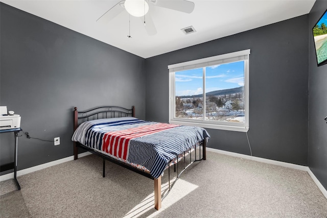 bedroom with carpet floors, visible vents, and baseboards