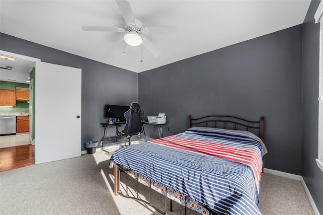 carpeted bedroom with a ceiling fan and baseboards