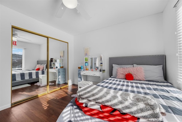 bedroom featuring a closet, wood finished floors, a ceiling fan, and baseboards