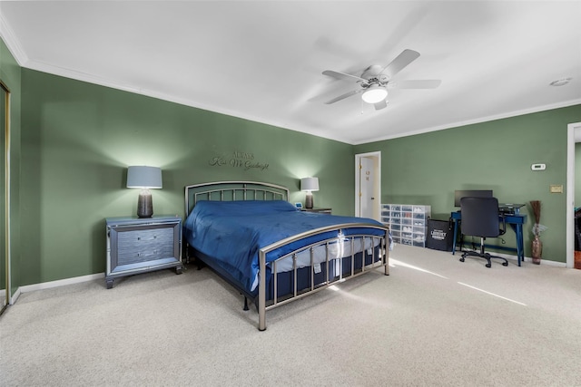 carpeted bedroom with baseboards, a ceiling fan, and crown molding