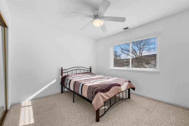 carpeted bedroom featuring a ceiling fan, baseboards, visible vents, and a closet