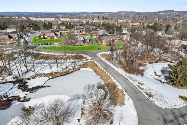 snowy aerial view featuring a residential view