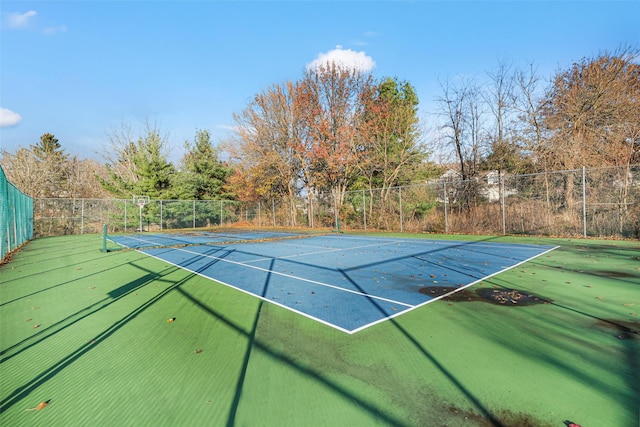 view of tennis court with fence