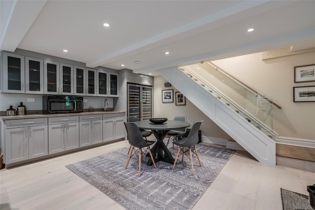 dining room featuring light wood-style floors, baseboards, and recessed lighting