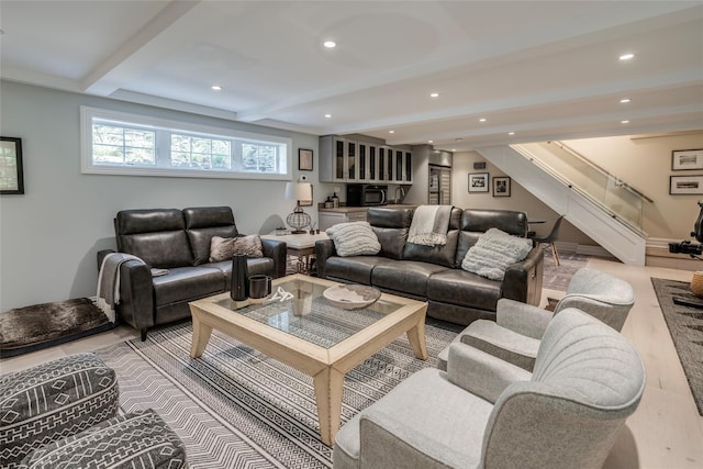 living room featuring light wood-type flooring, recessed lighting, beam ceiling, and stairs