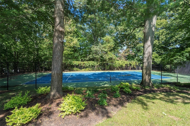 view of tennis court featuring fence