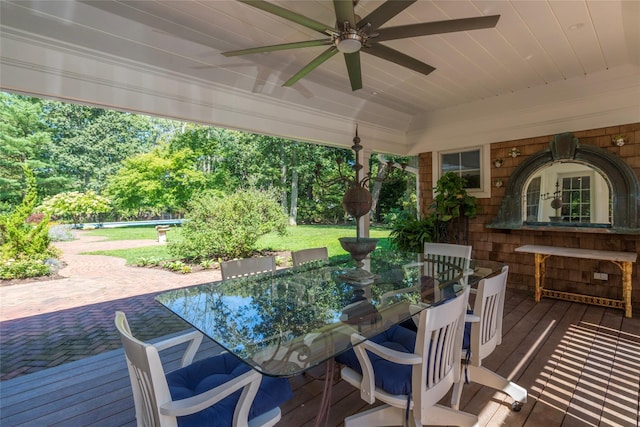 view of patio featuring outdoor dining space, ceiling fan, and a wooden deck