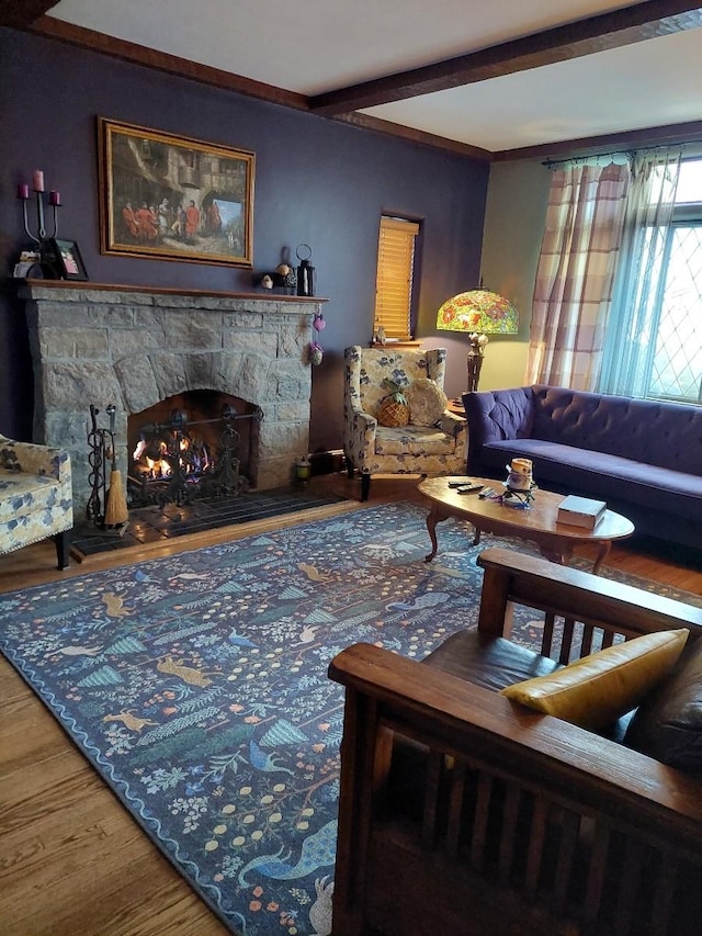 living room with a fireplace, wood finished floors, and beam ceiling