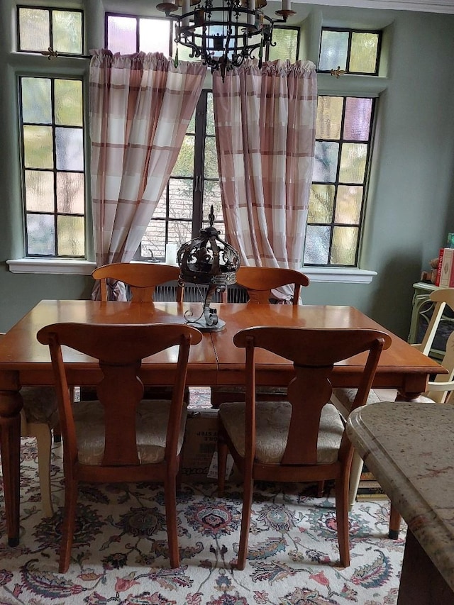 dining area featuring an inviting chandelier and a healthy amount of sunlight