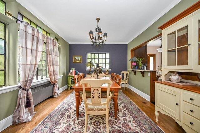 33-64 190th St, Flushing, NY 11358 - dining room with a chandelier, ornamental molding, baseboards, and light wood-style floors