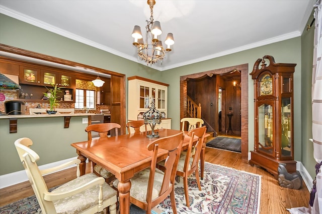 33-64 190th St, Flushing, NY 11358 - dining room with stairway, a chandelier, wood finished floors, and crown molding