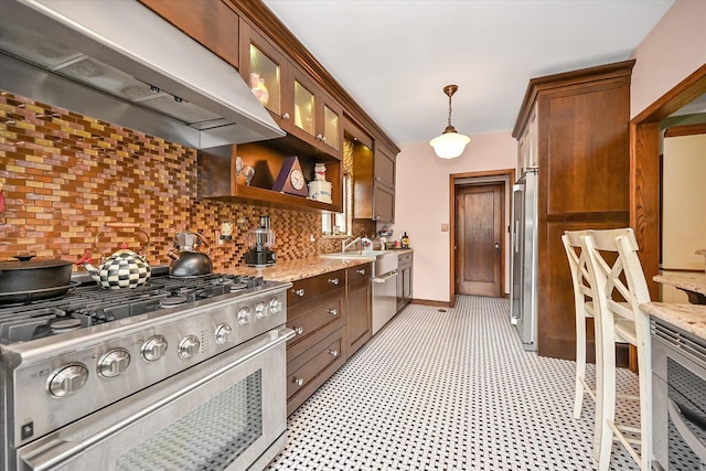 33-64 190th St, Flushing, NY 11358 - kitchen with premium appliances, under cabinet range hood, backsplash, and light stone counters