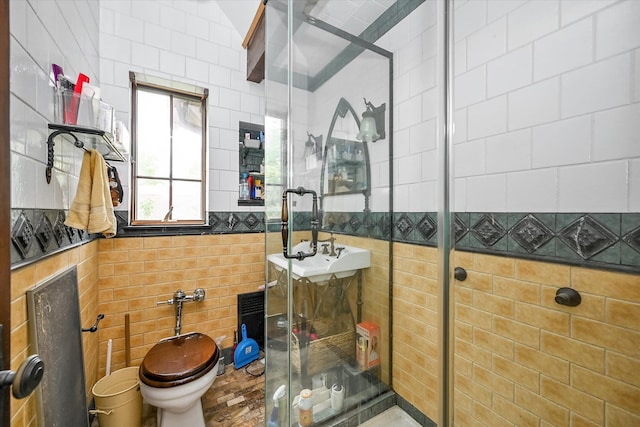 33-64 190th St, Flushing, NY 11358 - full bathroom with tile walls, a stall shower, a sink, and toilet
