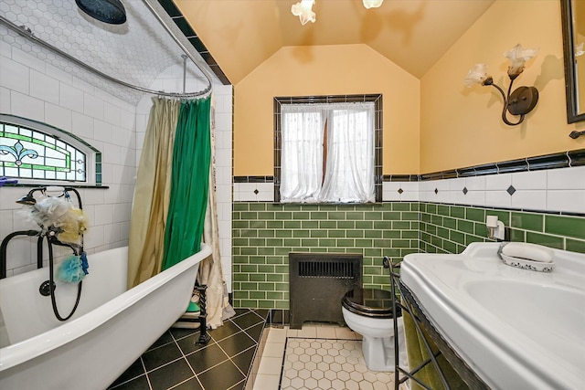 33-64 190th St, Flushing, NY 11358 - bathroom with tile walls, radiator heating unit, plenty of natural light, toilet, and tile patterned flooring