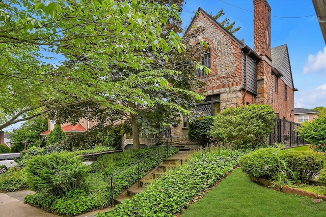 33-64 190th St, Flushing, NY 11358 - view of home's exterior with a chimney and stone siding