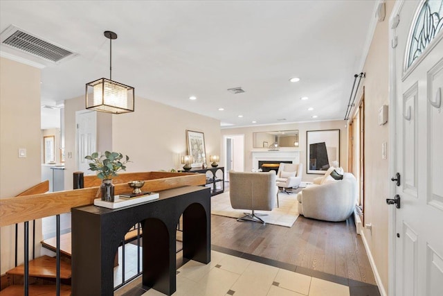 interior space with decorative light fixtures, recessed lighting, a fireplace, and visible vents