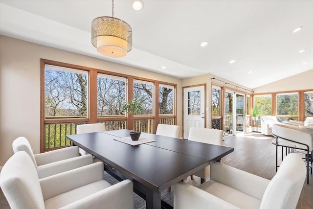 dining space with recessed lighting, lofted ceiling, and wood finished floors