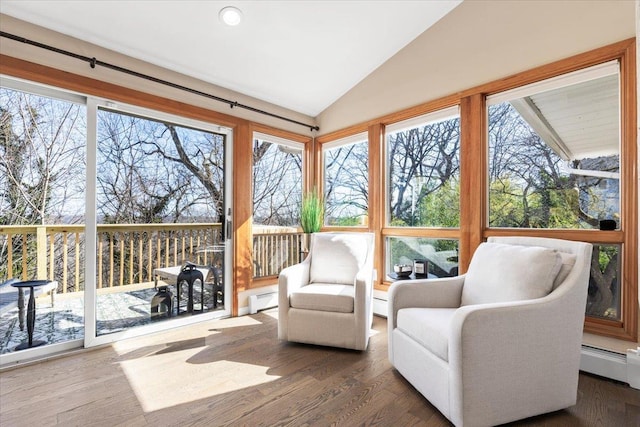 sunroom featuring lofted ceiling, a wealth of natural light, baseboard heating, and a baseboard radiator