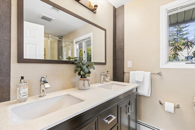 full bathroom featuring visible vents, tile walls, and a sink