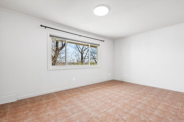 spare room featuring baseboards and ornamental molding