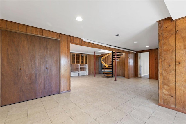 interior space with stairs, wooden walls, and recessed lighting