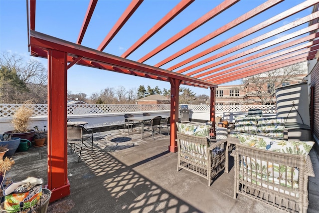 view of patio featuring outdoor lounge area, fence, outdoor dining area, and a pergola