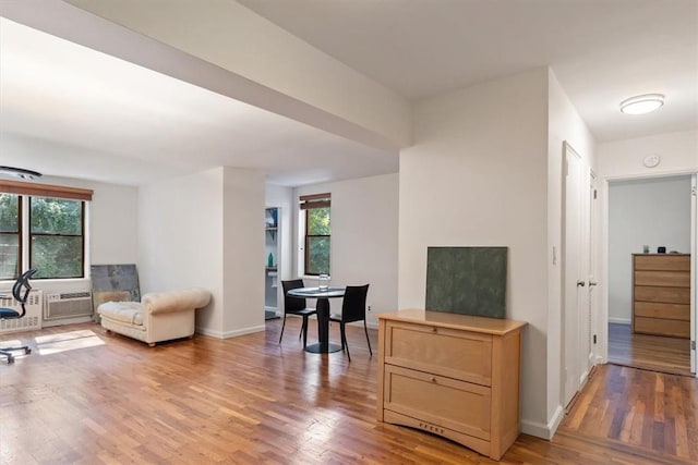 sitting room featuring baseboards, a wealth of natural light, and wood finished floors