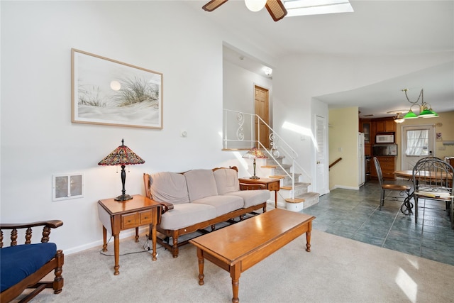 living room featuring lofted ceiling, visible vents, carpet, and stairs