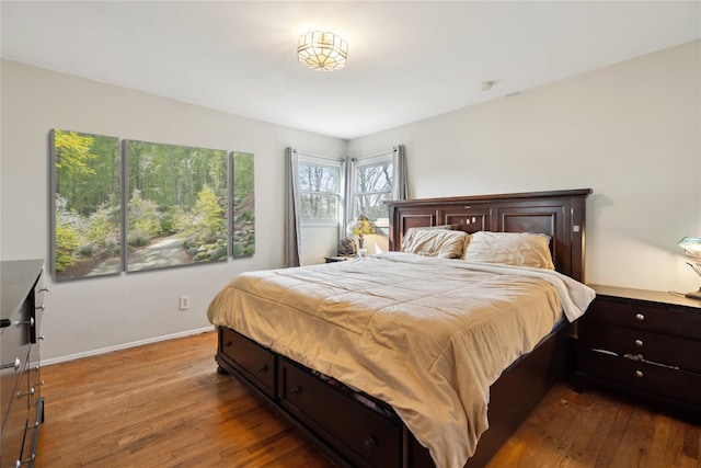 bedroom featuring light wood-type flooring and baseboards