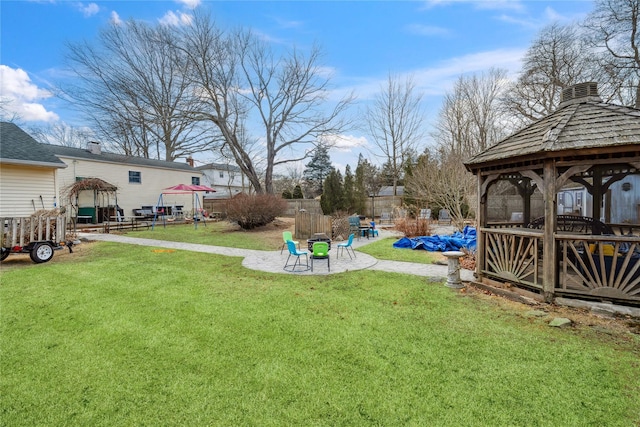 view of yard with a patio area, fence, and a gazebo