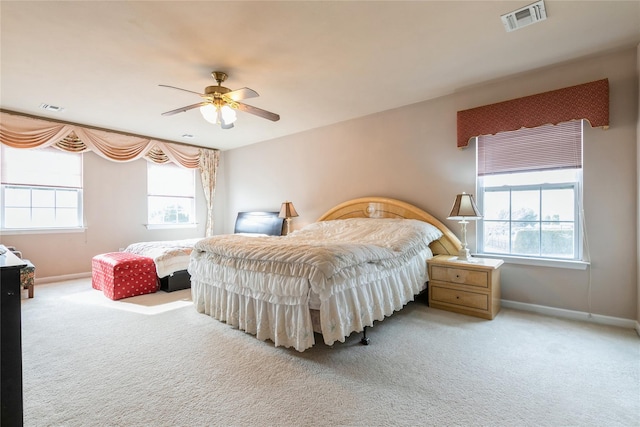 bedroom with carpet floors, multiple windows, and visible vents