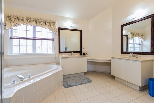 full bath featuring two vanities, a sink, a bath, and tile patterned floors