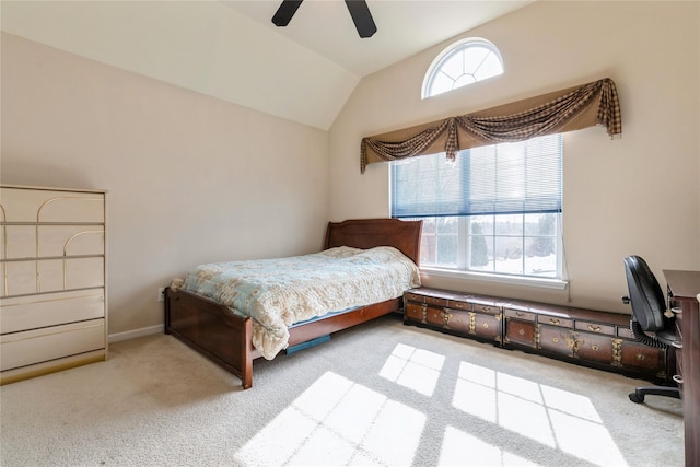 bedroom with lofted ceiling, baseboards, a ceiling fan, and light colored carpet