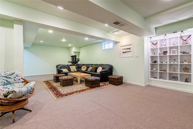 carpeted living area with recessed lighting, visible vents, and baseboards