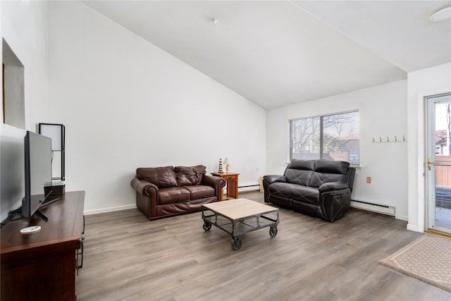 living room with baseboards, a baseboard heating unit, vaulted ceiling, and wood finished floors