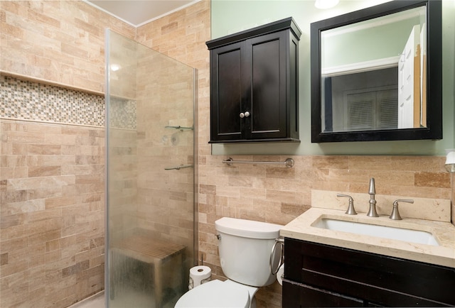 full bathroom with toilet, tile walls, a shower stall, and vanity