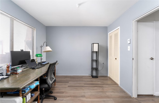 office area with wood finished floors and baseboards