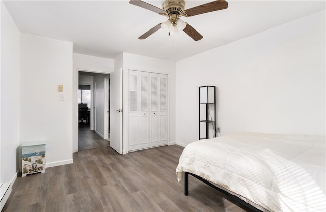 bedroom with a closet, baseboards, and wood finished floors