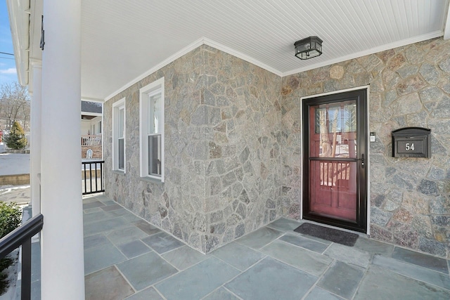 entrance to property featuring stone siding